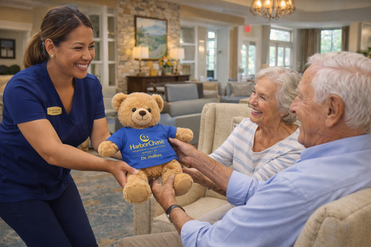 Custom teddy bear wearing a branded mini shirt created with DTF printing for a holiday gift at HarborChase Senior Living in Orlando.